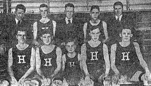 Standling, Left to right: Assistant Coach Regan, Donahue, manager Eastman, Graves, Coach Williams. Front Row -- Merriman, Capt. Feldman, Craimer (Mascot), McGuiggan, Malcolm.